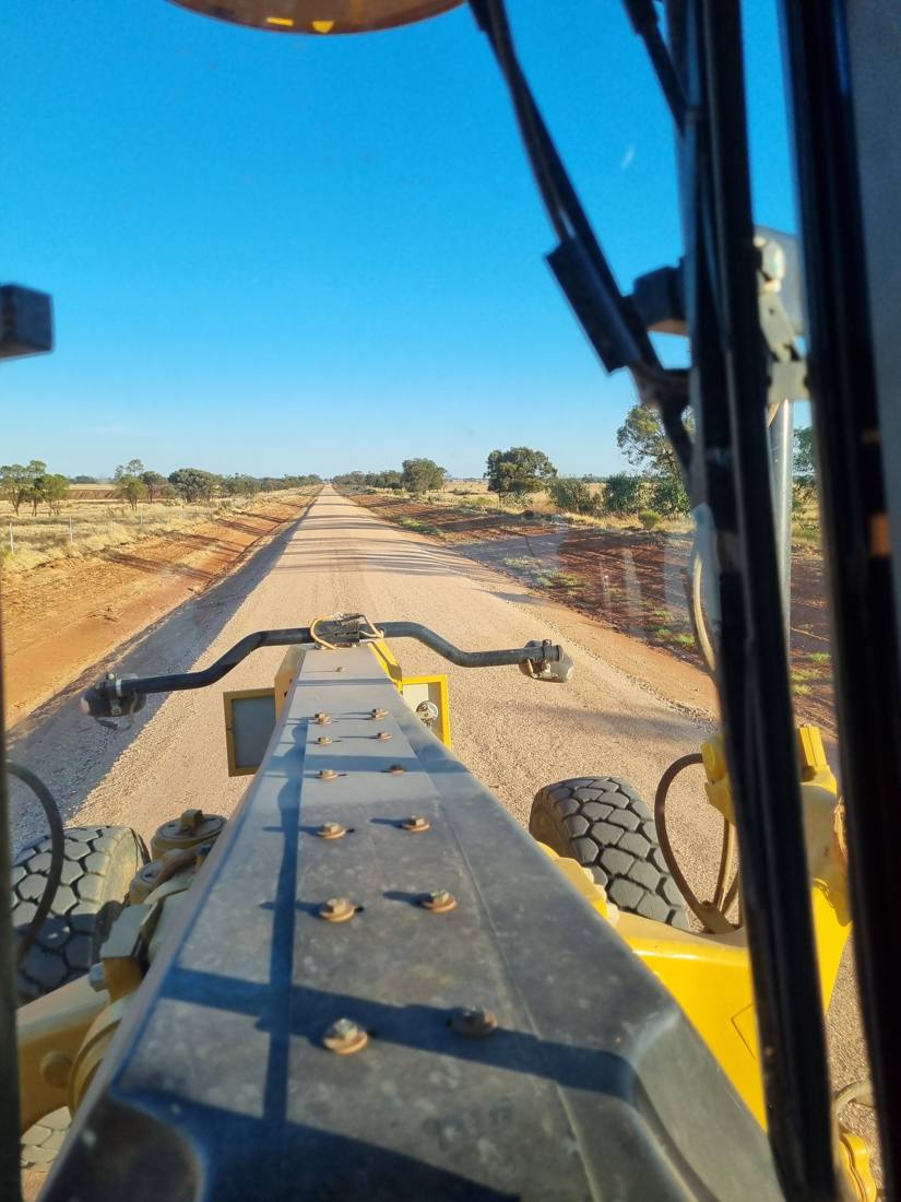 View from a grader cab over a freshly formed unsealed road